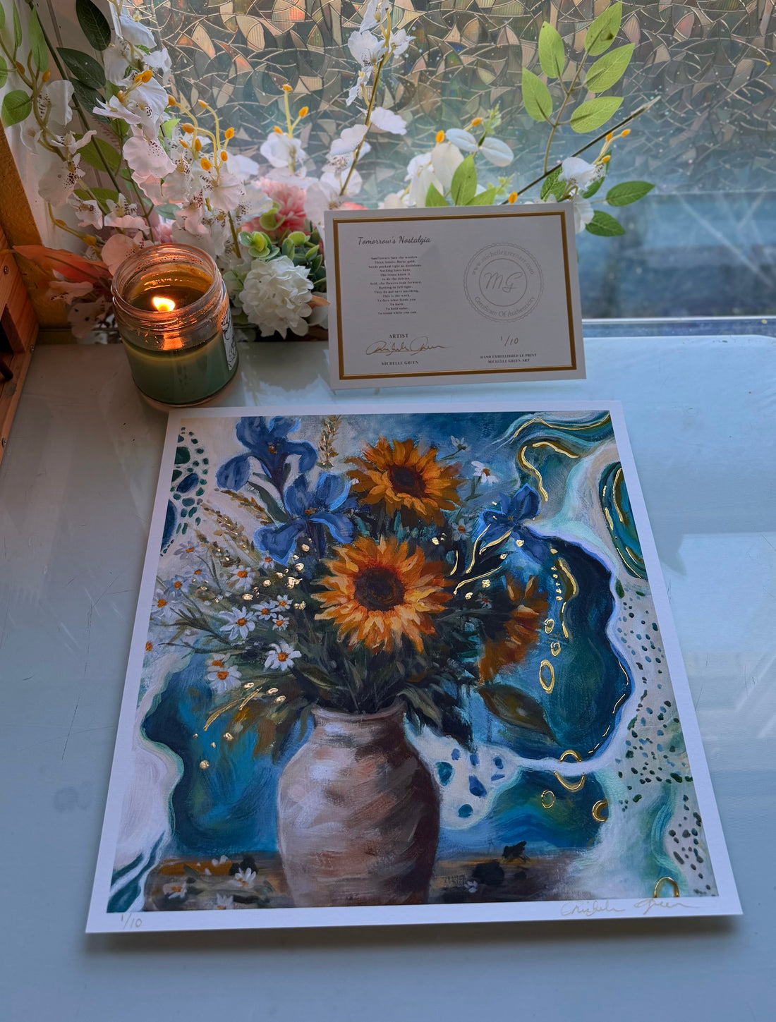 Card with a floral design featuring sunflowers and blue flowers held by a hand.