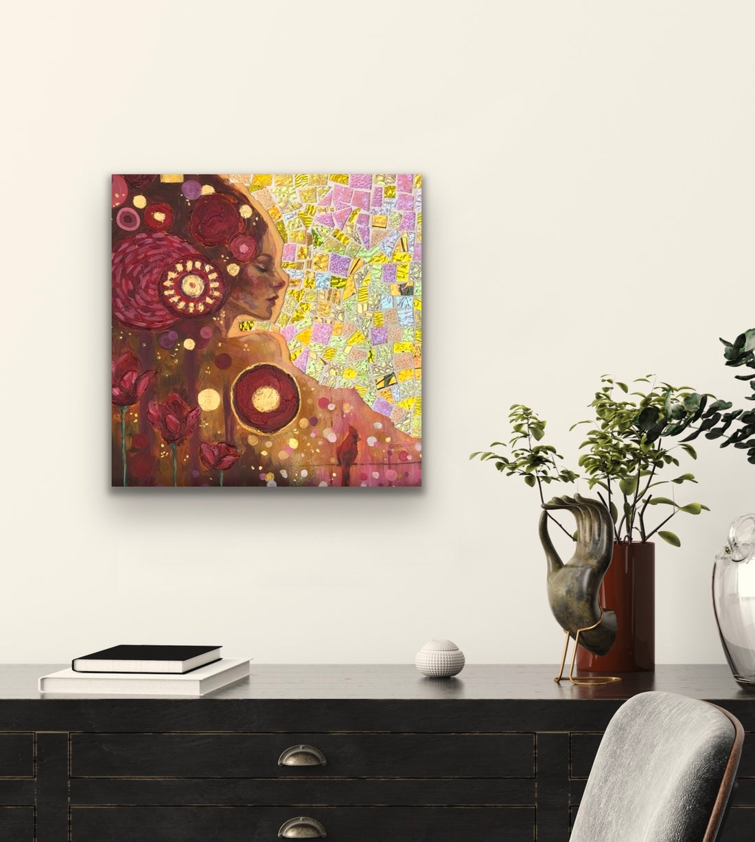 Abstract painting on a wooden easel against a gray wall