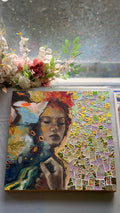 Artistic depiction of a woman with flowers and a mosaic pattern on a textured surface.