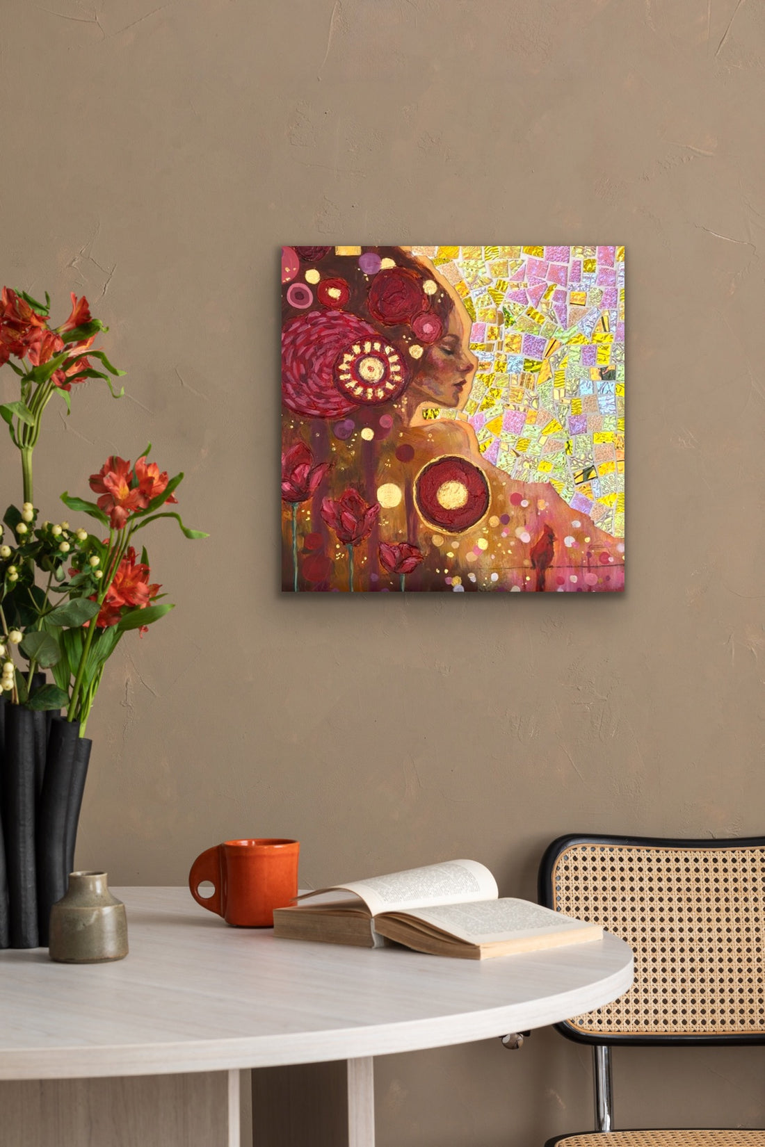 Two abstract artworks on an easel against a gray wall.
